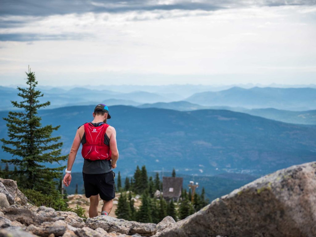 Man trail running at top of Red Mountain